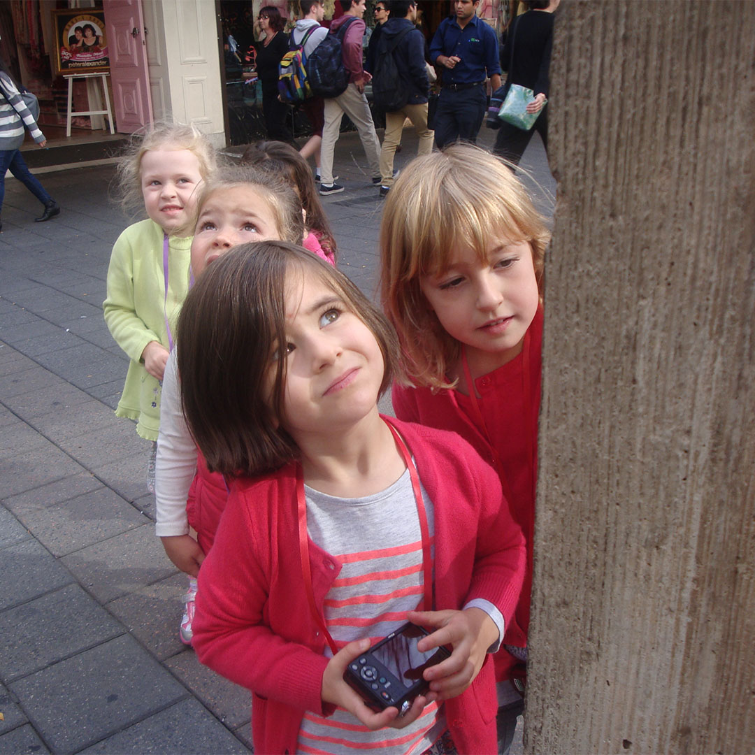 four children looking at a post